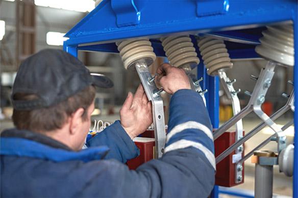 Man working under electrical equipment